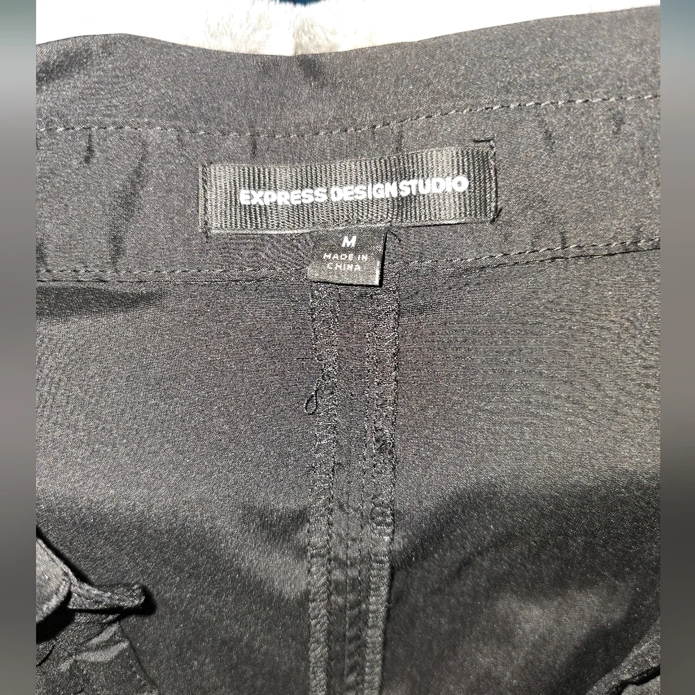 Express black size M womens blouse. Side zipper with buckle accent in front‎